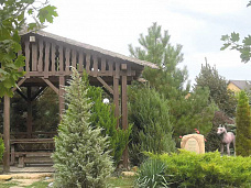 Беседка и камень с надписью, установленный в честь колхоза «Волна революции».