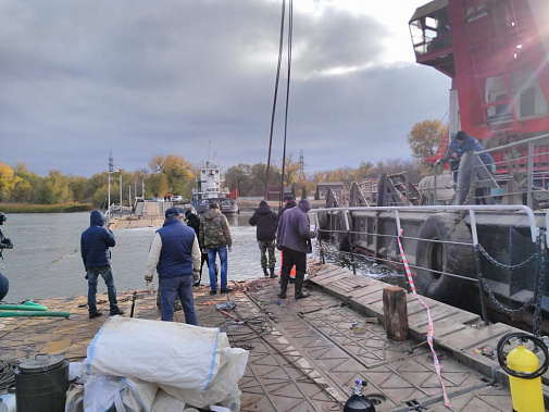 Одну из секций понтонного моста на Зеленый остров уже подняли